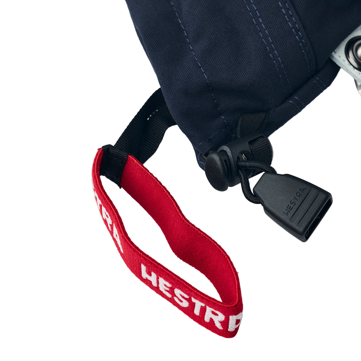 Red strap with 'HESTRA' branding on a black bag against a white background