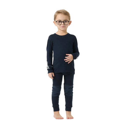 A young boy wearing a dark navy blue long-sleeve pajama set with matching pants and round black glasses, standing against a light gray studio background.