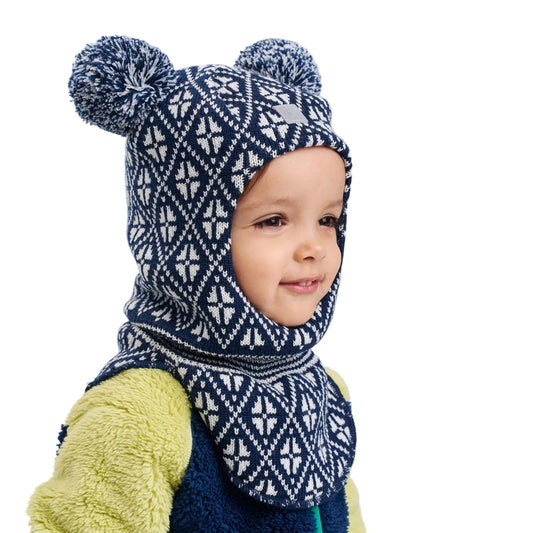 Child wearing a blue and white patterned knit balaclava and scarf on a light gray background