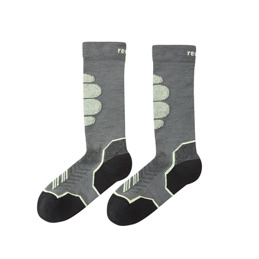 A pair of crew-length athletic socks in heather gray with black heels, toes, and heels, featuring light green geometric patterns and a small green 're' logo near the top cuff, shown against a plain white background.