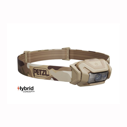 A Petzl headlamp with a desert camouflage pattern in tan and brown, featuring a beige plastic housing and a clear lens. The Petzl logo is visible on the strap, and a 'Hybrid Concept' logo is shown in the bottom-left corner.