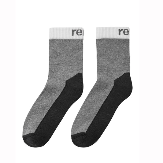 A pair of kid's crew socks in heather gray and black with a white ribbed cuff, featuring the partial brand name 're' printed in black on the white cuff.
