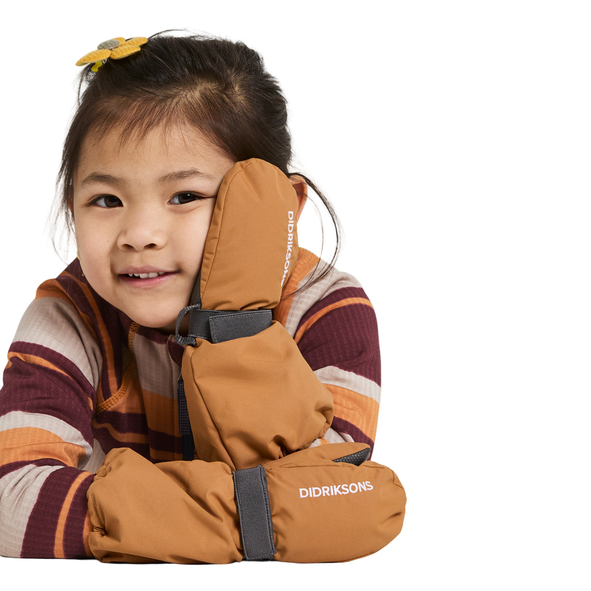 Child wearing brown Didriksons gloves on a white background