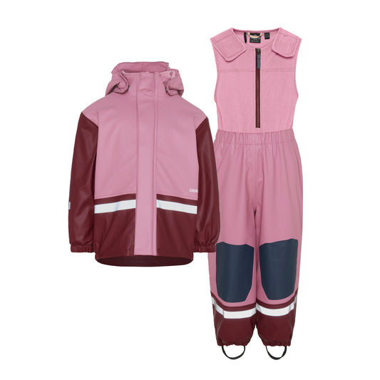 Kids Pink and maroon raincoat and dungareed set on a white background