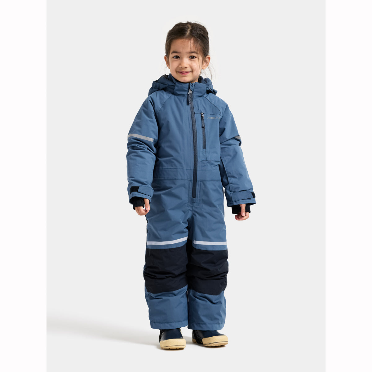 Child wearing a blue snowsuit on a white background