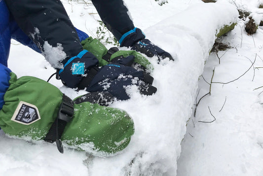 Kids ski gloves in snow