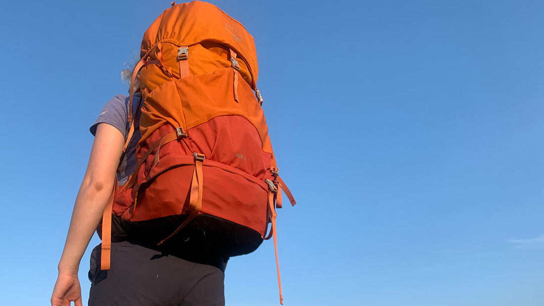 Girl carrying an Osprey Ace 50 hiking backpack