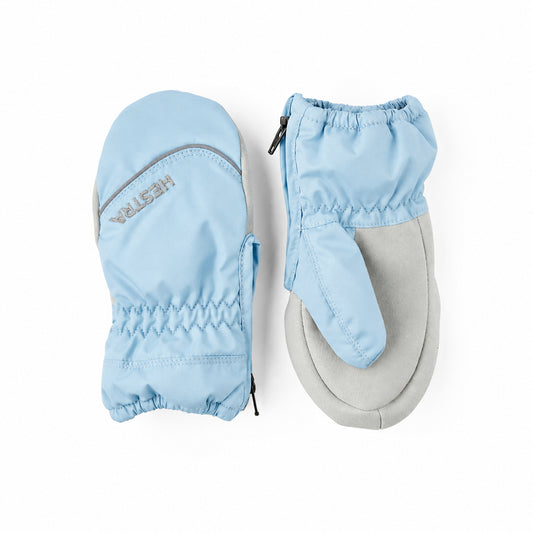 A pair of light blue and grey baby mittens shown flat against a white background, with one mitten displaying the 'HESTRA' brand name.