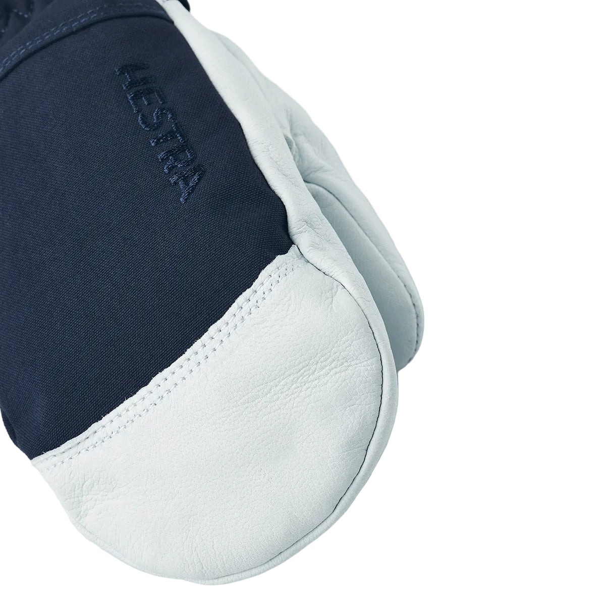 White and navy blue shoe with 'Hestra' branding on a white background