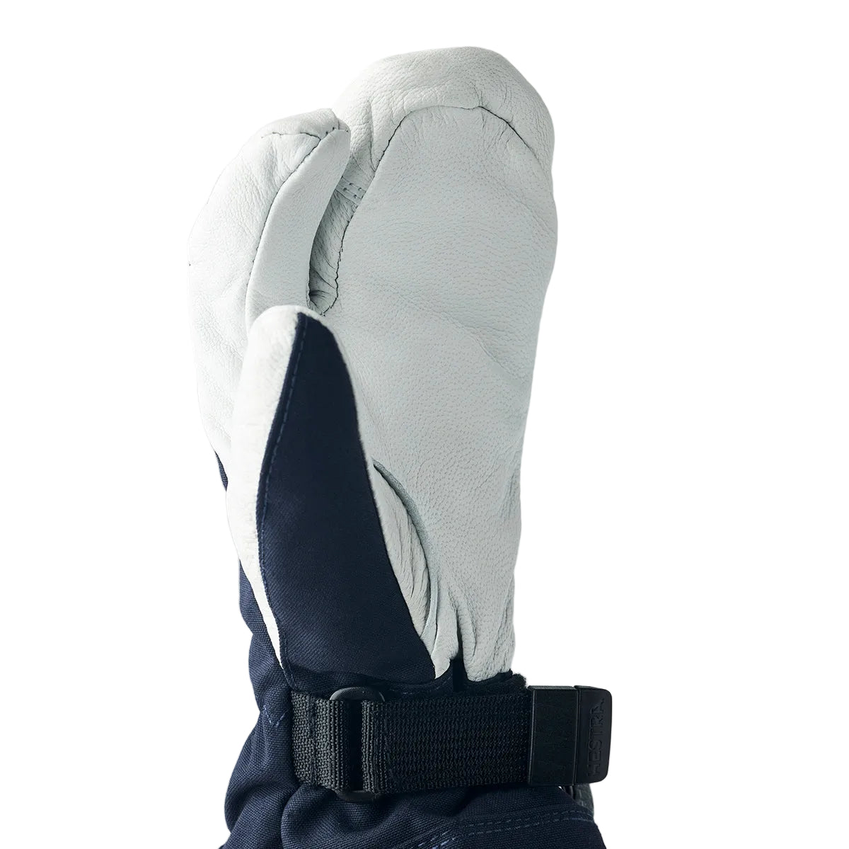 Gray and navy winter glove with a black strap on a light gray background