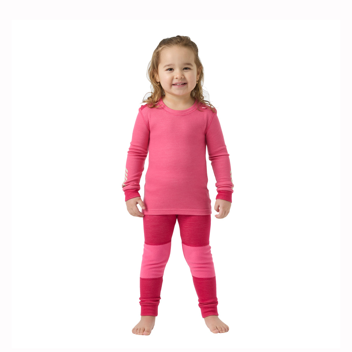 gilrl wearing pink thernal top and bottoms on a white background