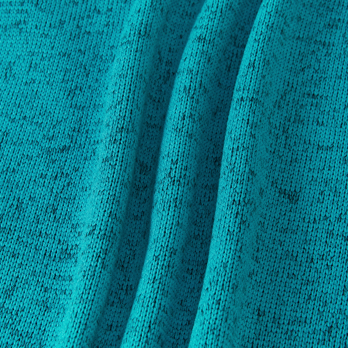 A close-up of textured knit fabric in a bright turquoise blue color with subtle dark heathering, shown with soft folds.