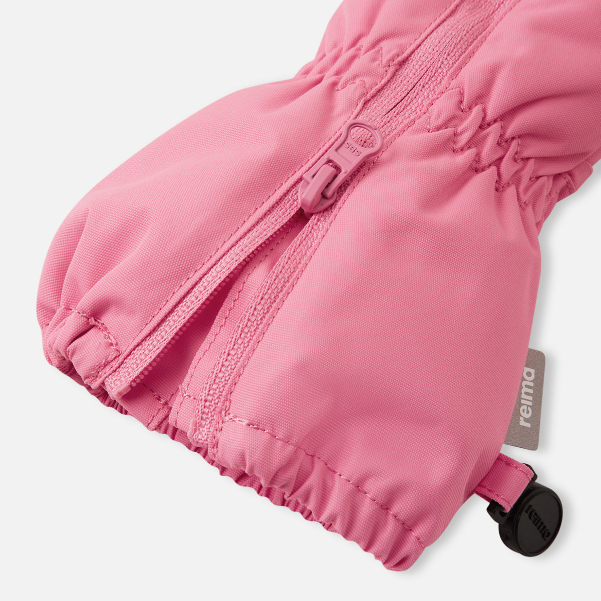 Pink baby bootie with a visible brand label on a white background