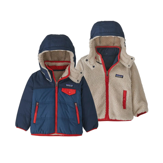 Two hooded children's jackets shown on a light gray background: one navy quilted jacket with red trim and beige sherpa lining, and one cream sherpa jacket with red trim and navy hood.