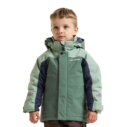 A young boy wearing a green and navy blue hooded winter jacket with the brand name 'Didriksons' printed on the chest, set against a plain light grey background.