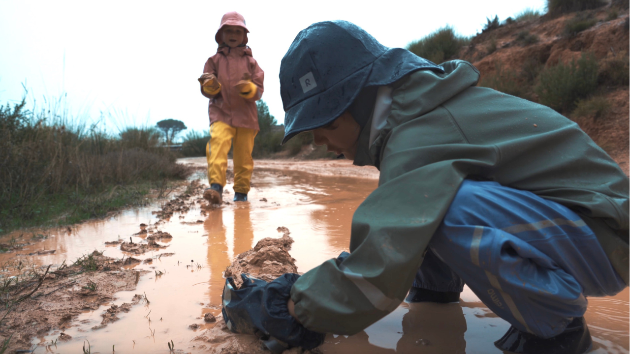 Load video: Video of kids playing in muddy puddles