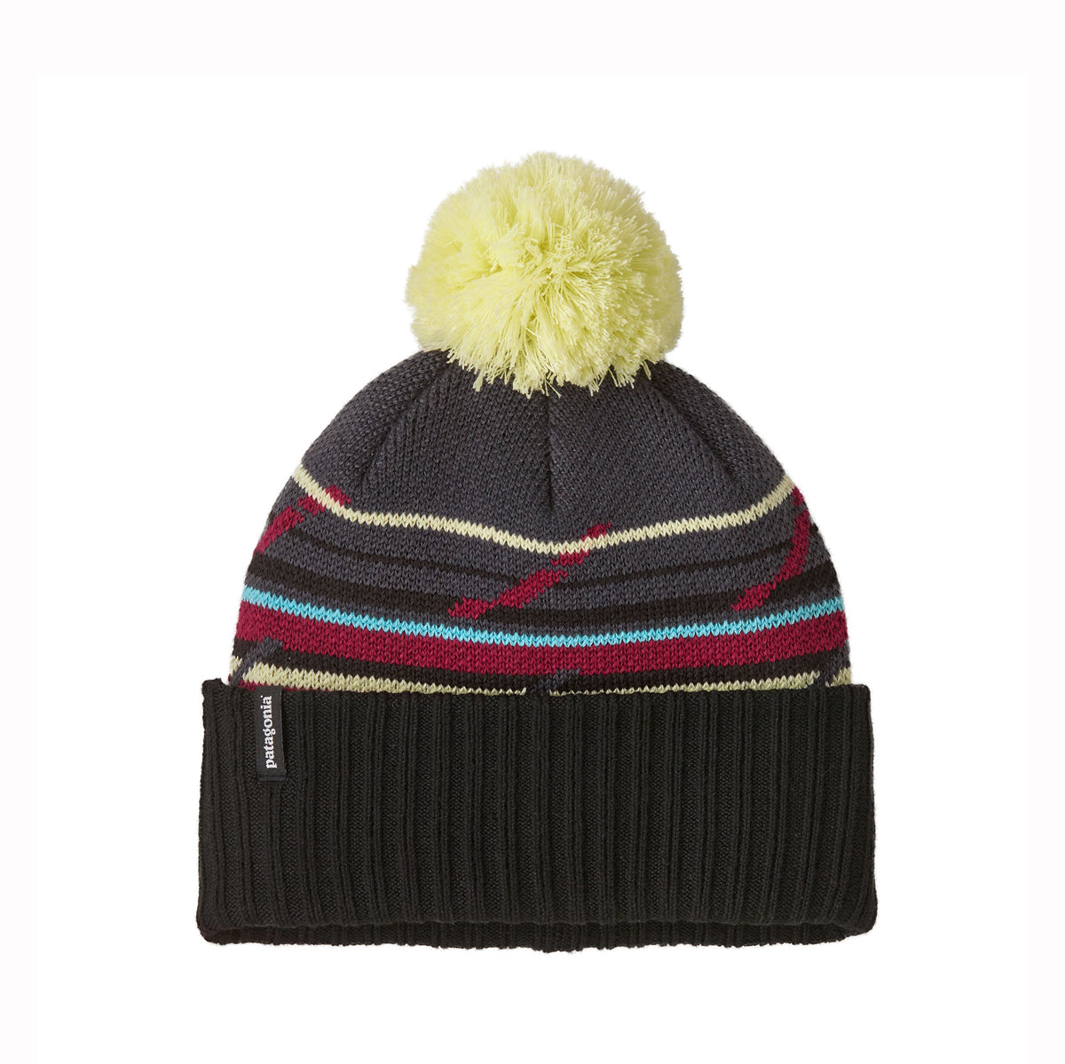 A knit beanie hat with a dark gray upper section, multicolor horizontal stripes in red, light blue, beige, and burgundy, a black ribbed cuff, and a fluffy pale yellow pom-pom on top. A small Patagonia tag is visible on the cuff.