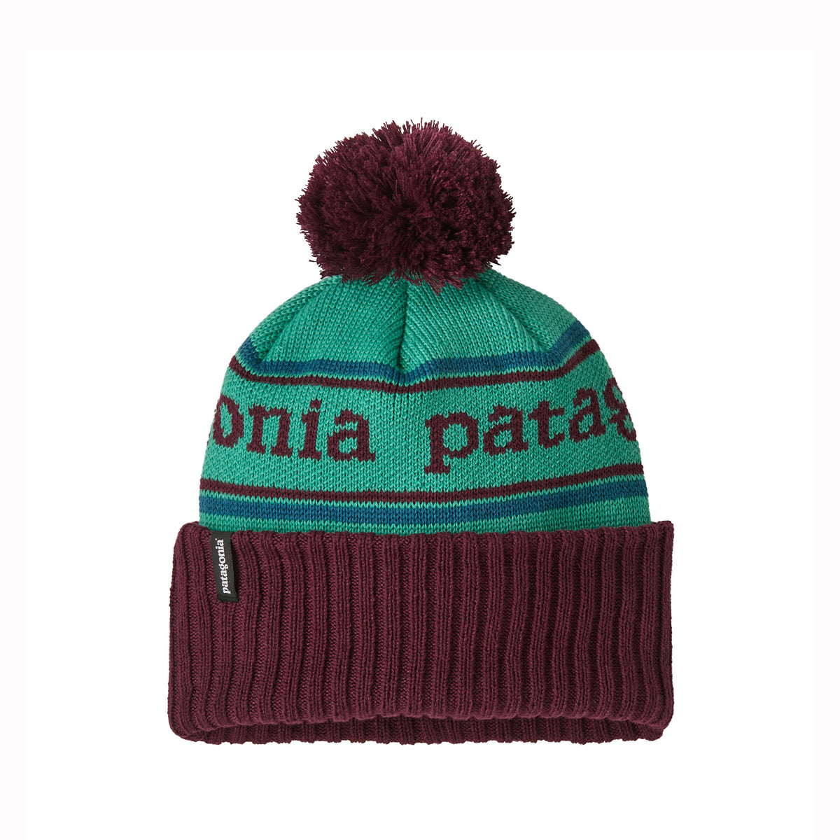 A knit beanie hat with a green crown, burgundy ribbed cuff, and burgundy pom-pom. The crown has horizontal stripes and the words 'Patagonia' knitted across the front.
