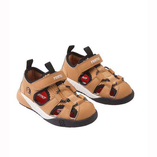 Pair of tan children's sandals with black soles on a white background