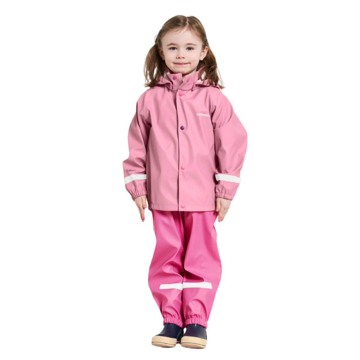 Child wearing a pink raincoat and pants on a white background